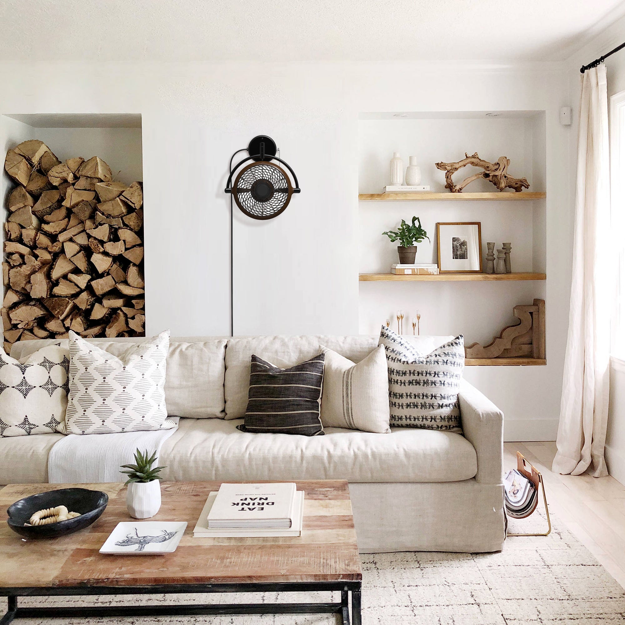 Black wall-mounted ceiling fan in a modern living room