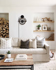 Black wall-mounted ceiling fan in a modern living room
